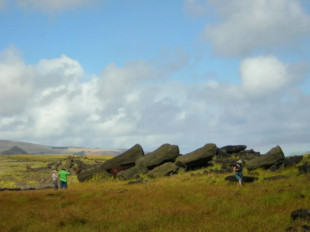 Toppled moai at Ahu Ura Uranga Te Mahina on Rapa Nui with field crew mapping nearby